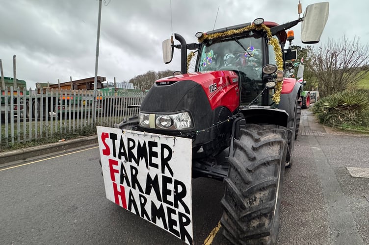 ‘Starmer Farmer Harmer’ read a sign on one of the tractors taking part in the charity run.  AQ 0933

