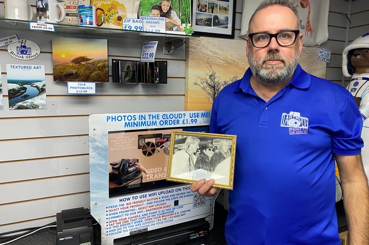 Keith Hall, former Dartmoor Photographic owner, with celebrity photo Elton John,  Ian Botham and XX?