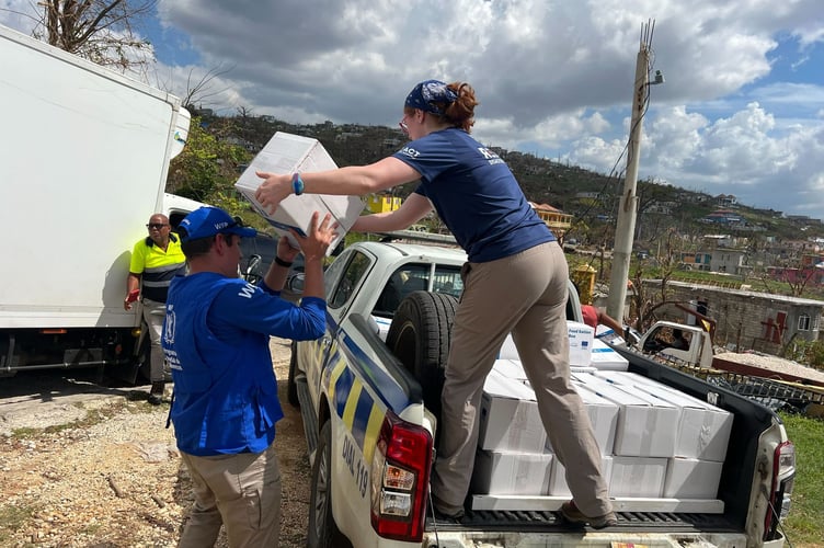 A REACT volunteer handing aid to another worker during last year's Jamaica hurricane disaster. Picture by Kirsten Edmonds-Bailey.