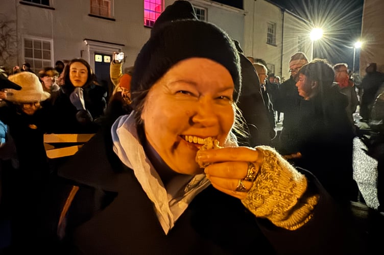 Tracey Norman eats apple cake at Sandford Wassail.  AQ 2192
