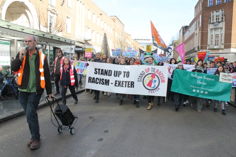 The Stand up to Racism march moves down Exeter High Street.  AQ 0970
