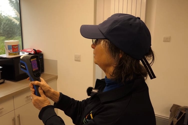 Kate Royston, of Tavistock Energy Community, using a thermal imaging camera which is offered to householders to cut bills.