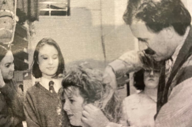 Giovanni Sponziello pictured at styling a customer at a Plymouth Co-op hair salon.