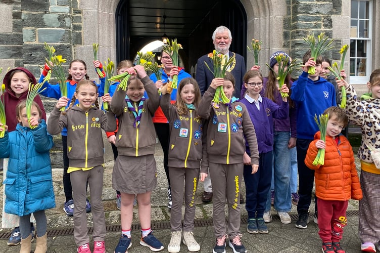 Bringing spring to the high street are schools and Brownie and Guide groups to mark Tavistock BID's Paint the Town project.