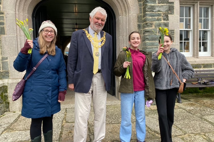 Bringing spring to the high street are Brownie and Guide groups to mark Tavistock BID's Paint the Town project.