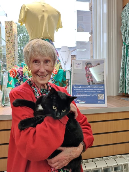 Pam Hoare with Sir Polo the cat at the Devon Air Ambulance shop in Tavistock