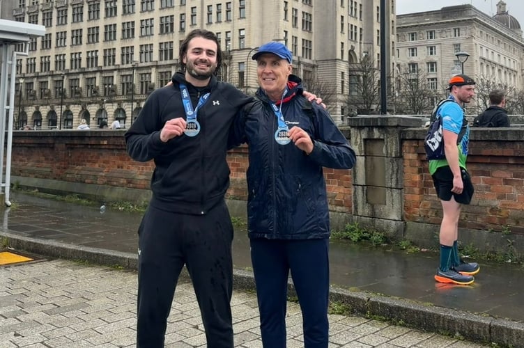 Simon O'Neill and his nephew with their medals at the Liverpool Half Marathon.
