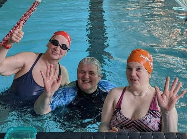 A triumphant Carol Gander, left, at the finish of her mass charity swim in Mount Kelly College pool in Tavistock.  Picture by Amanda Massey.