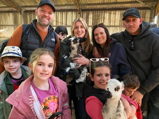 Families embrace lambs at farm open day