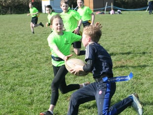 Hard tackling at primary school rugby contest