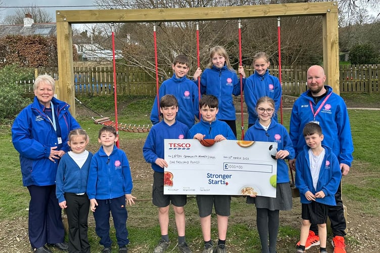 Headteacher Adam Hill celebrates Tesco funding boost with pupils at Lifton Community Academy