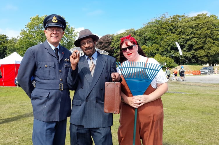 A scene from the 2025 1940s Weekend at RAF Harrowbeer - an RAF officer, a spiv and a land girl