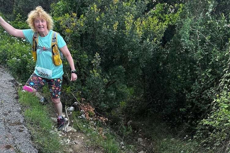 Dotty King scrambling across the rugged terrain of Corfu on a gruelling 15-mile night mountain running race.