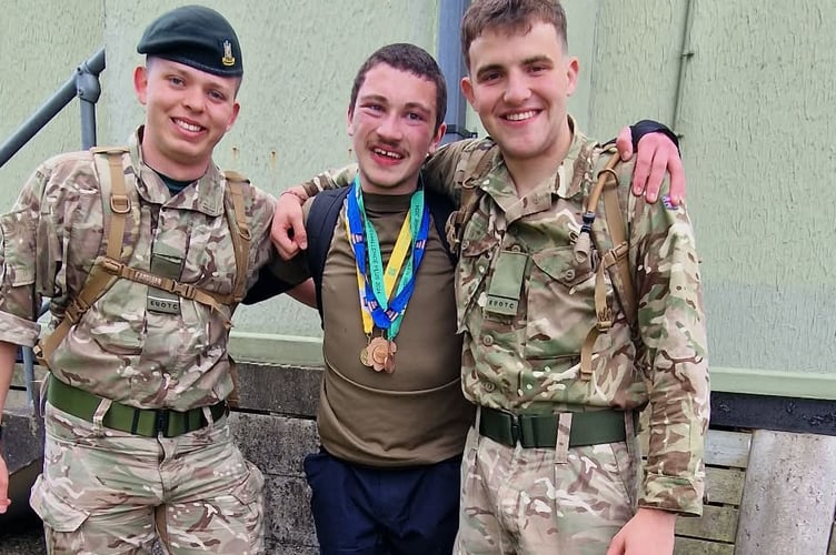 Damien Bowyer, of Tavistock, congratulated by soldiers after finishing the Ten Tors Jubilee Challenge with a gold medal.