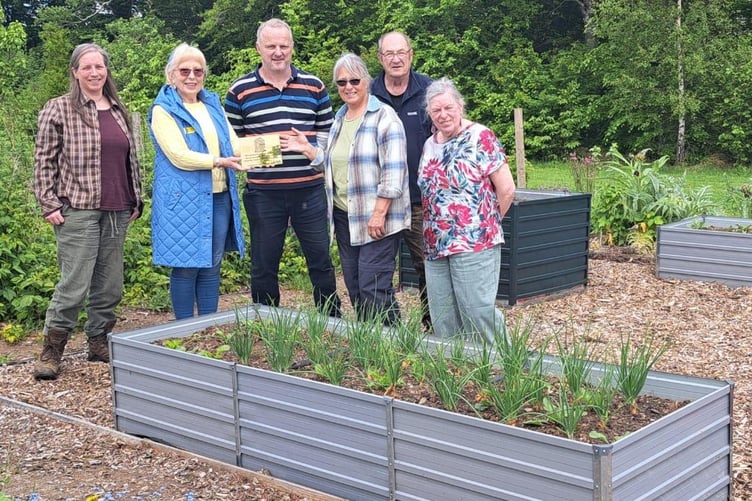 Okehampton Community Garden volunteers with the National Garden Scheme grant plaque.