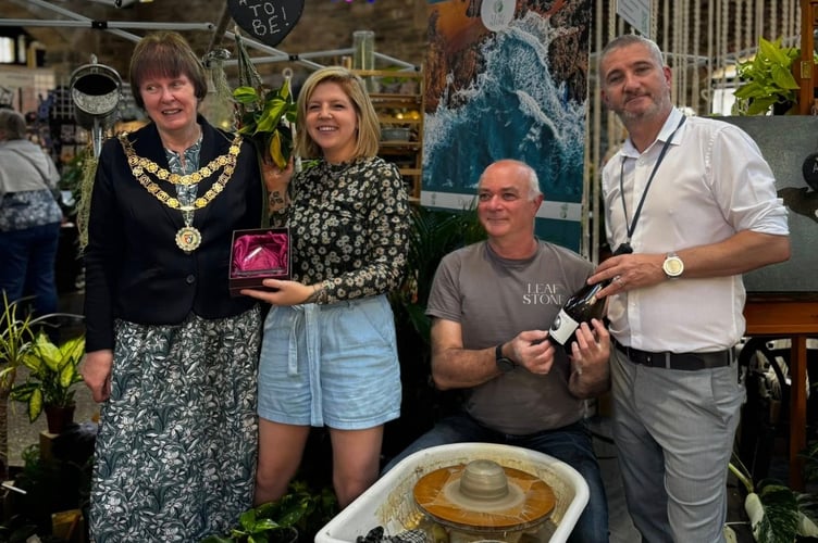 Tavistock plant and pottery shop Leaf and Stone receives a green-fingered award from new-elected Mayor Cllr Anne Johnson at Tavistock Country Garden Show in the Pannier Market. Picture Tavistock Town Council.