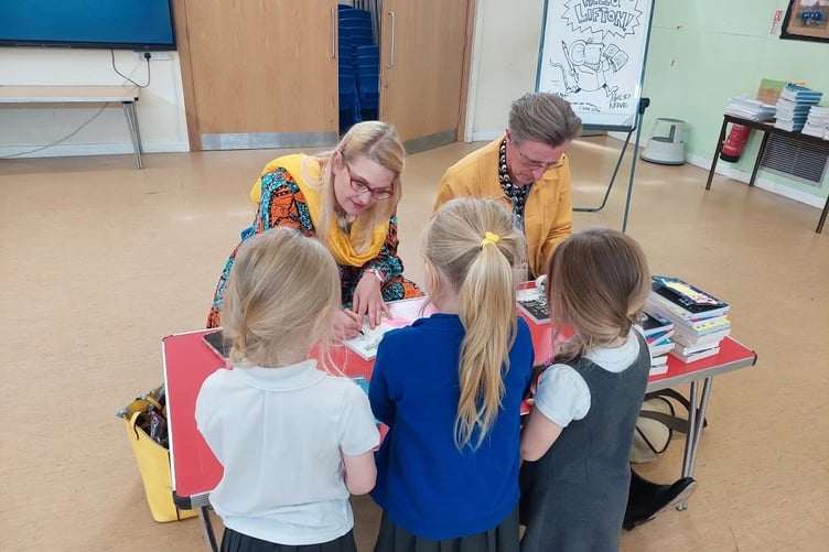 Authors Sarah McIntyre and Philip Reeve sign their books for Lifton pupils.