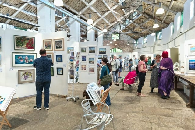 The Drawn to the Valley group of artists is staging its summer show in July in Tavistock's Butcher's Hall. Pictured is a previous exhibition in the hall.