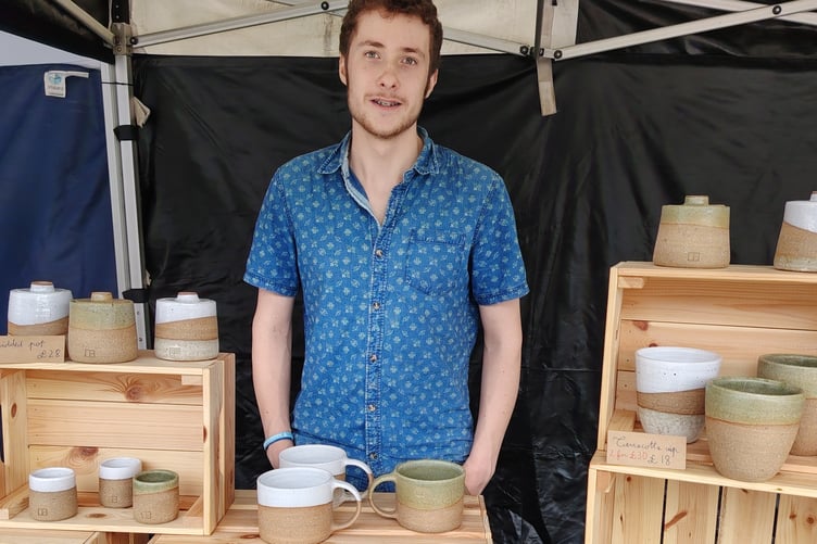 Oscar Black, 18, proudly showing off his own pottery creations at the SW regional young market traders competition in Plymouth.