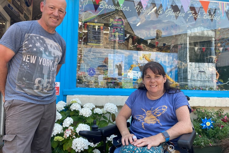Tina Willcocks, of Tavistock, has launched a successful sticker campaign to highlight shops with mobility access. She is pictured outside Dot's Health Foods with Phil King.
