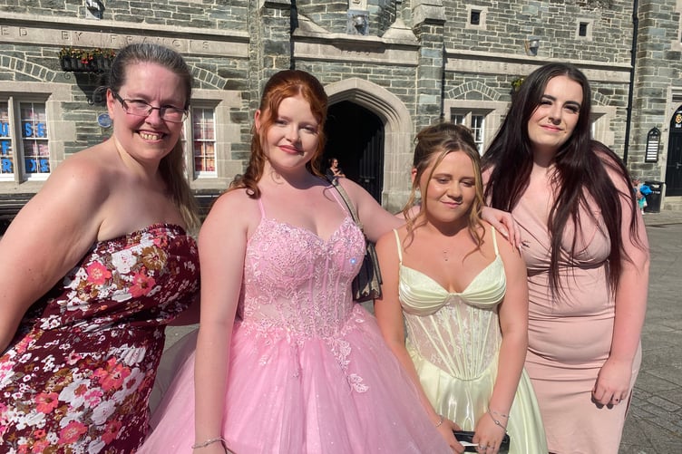 Glittering in their finery are Tavistock College students gathering in the town centre before their end of school proms. Pictured are students second and third left) Sienna Miller and Mikayla Hicks-Cole with Susan Miller (Sienna's mum) and Verona May (sister of Sienna, far right).