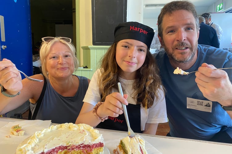 Harper tickled the judges' tastebuds by winning Princetown School's bake-off competition. She is pictured with her parents Laura and Glen digging into her rainbow cake.