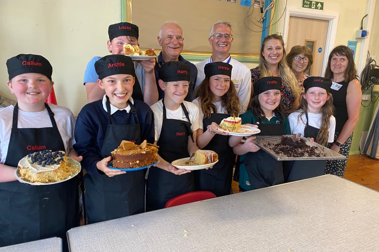 Proud young bakers, judges and Yelverton Rotary Club members at Princetown School's pupils' bake-off competition.