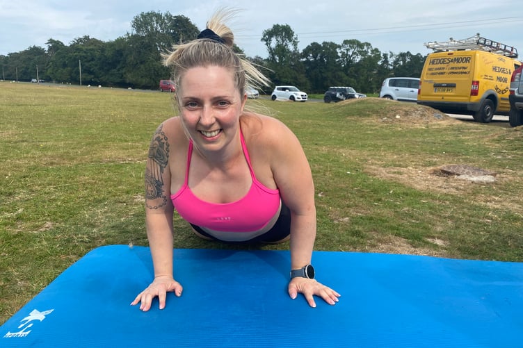 Lorna gets to grips with a press-up as the organiser of the 1,000-repeat outdoor gym challenge in Whitchurch in aid of Tavistock Youth Cafe.