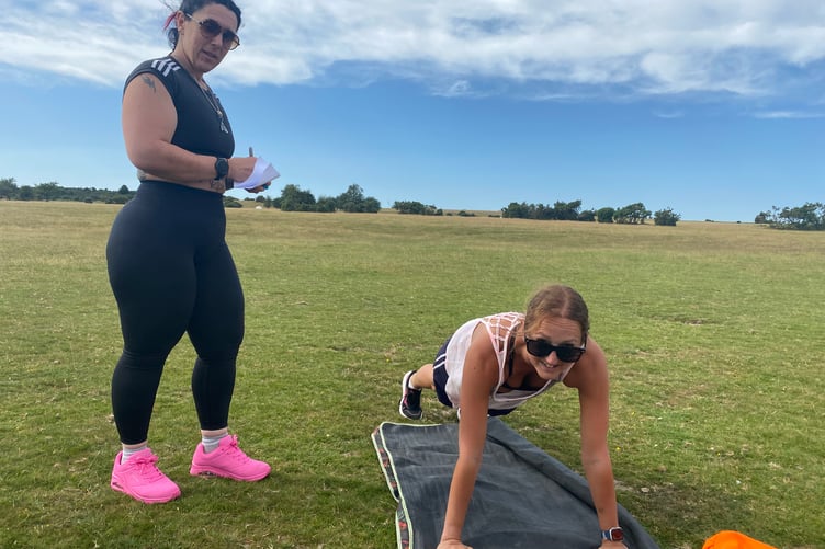 Keen gym exercise fans tackling the 1,000-repeat outdoor gym challenge in Whitchurch in aid of Tavistock Youth Cafe young people's group.