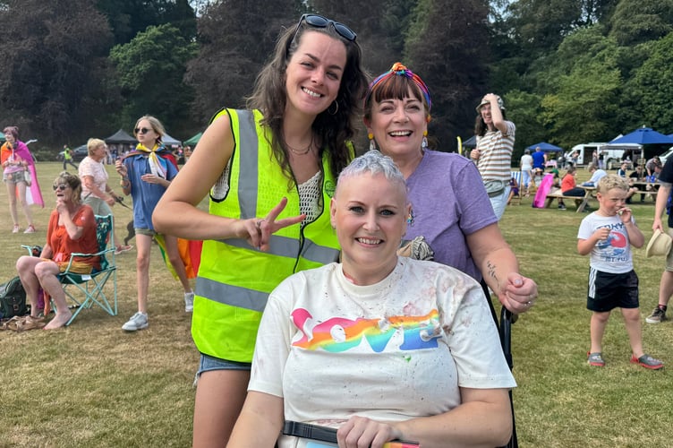 Happy faces of visitors and a steward at Okehampton Pride. AQ 5695