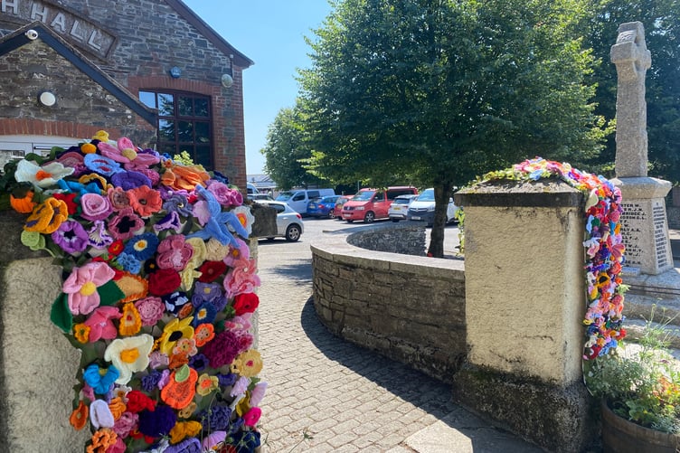 Crocheted floral banners welcome judges to Bere Alston hall forBowling for the Bere Alston In Bloom competition.
