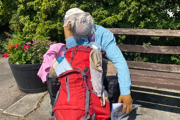 A scarecrow version of a weary traveller on a village bench made judges laugh for the Bere Alston In Bloom competition.