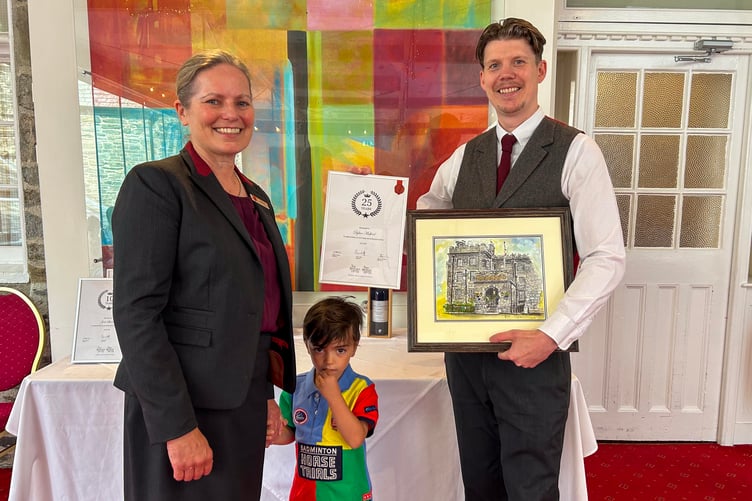From kitchen porter to general manager of the same hotel: Dylan Mulford has been awarded a 25-year service award at Tavistock's Bedford Hotel He is pictured with Warm Welcome Hotels Director Sarah Howard receiving his award.