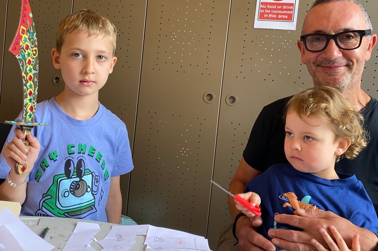 Theodore, six, brother Albert, 3, and grandad Robin, at a pirate-themed heritage children's activity session in Tavistock Guildhall.