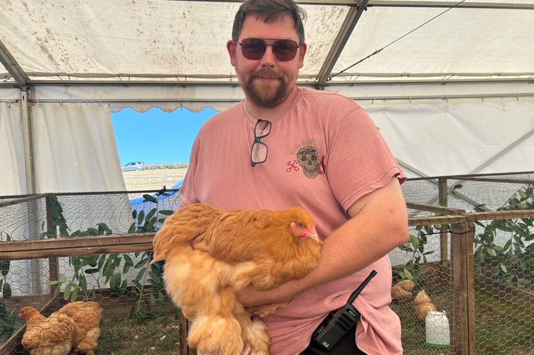 Ashley Hooper with a fluffy cochin hen in the Taw and Torridge Poultry Club marquee
