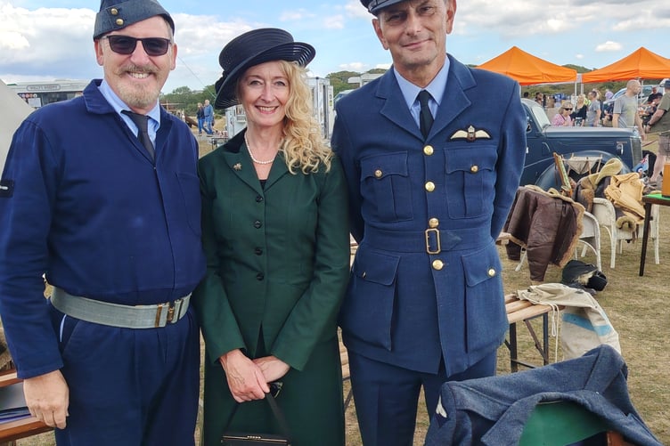 A pair of retro-airmen with a lady dressed in by-gone fashion at the RAF Harrowbeer 1940s Weekend.