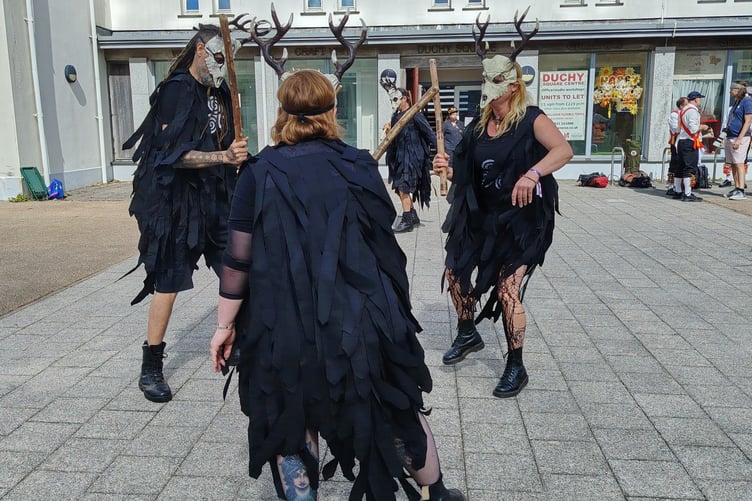 Dressed in black and wearing intimidating horned skull masks, a morris group entertained Princetown crowds at the mass celebrations of Border Morris group's 25 years.