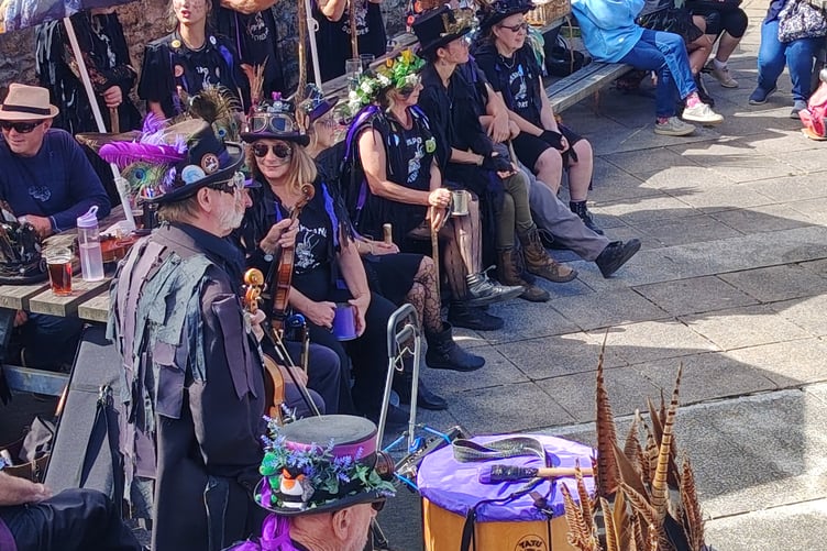 Taking a well-earned rest from the Princetown celebrations marking the Border Morris group's quarter century.