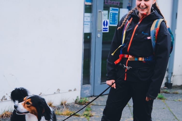 A happy walker with her dog celebrates finishing the 11 Tors trek on the moor in aid of Dartmoor Search & Rescue Team Tavistock. Picture by Matt Caine.
