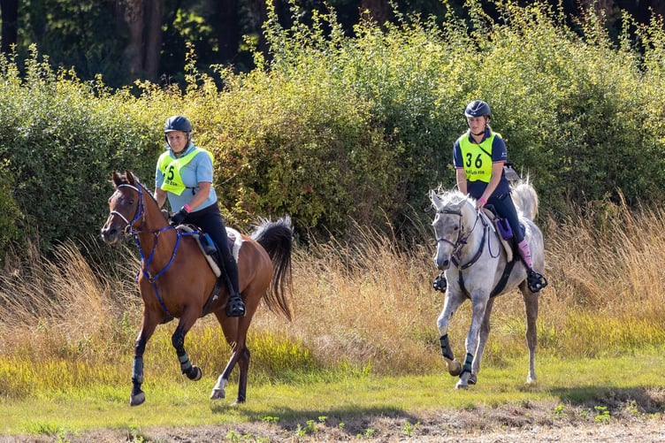 Abby riding with her mum, Jo Chisholm.