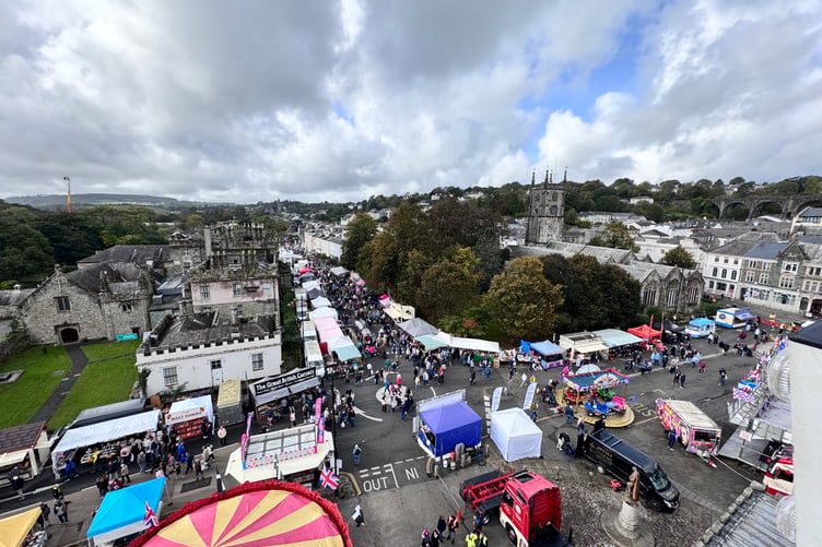 A bird's eye view of Tavistock Goose Fair looking down to Bedford Square and along Plymouth Road with busy streets of visitors.