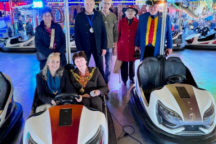 All the fun of the fair at the official opening of David Rowland & Sons Funfairs for Tavistock Goose Fair.
Pictured: Back; Nicola Jenkins, Cllr Chris Edmonds (West Devon Mayor), Alan Jenkins, Rosemary and David Turner (town crier and consort).
Seated; Cllr Laura Bird (Okehampton Deputy Mayor), Cllr Anne Johnson Tavistock Mayor.