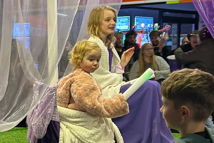 Princesses Amelia, foreground, and Layla-Grace Chastey wave to the crowds.