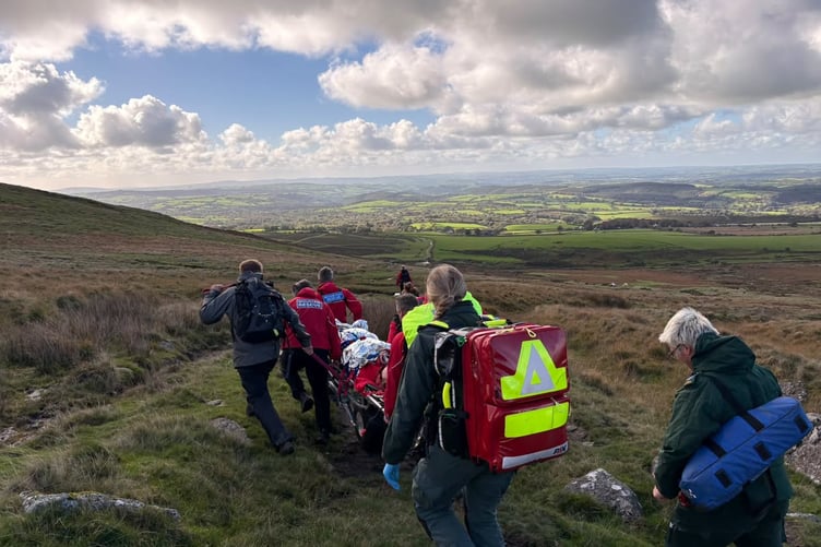 North Dartmoor Search and Rescue Team carry an injured runner to safety on. stretcher.