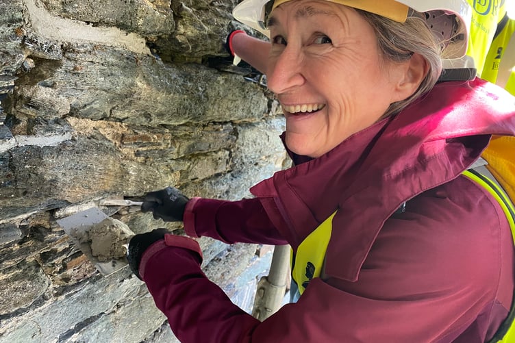 A Tavistock resident tries her hand at filling in stonework on Betsy Grimbal's Tower.