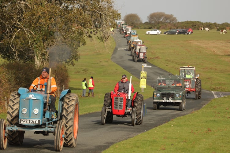 A noisy tractor run organised by farmer Fran Mudge chugs past spectators on its way from Sampford Spiney. Chris Cottrell.