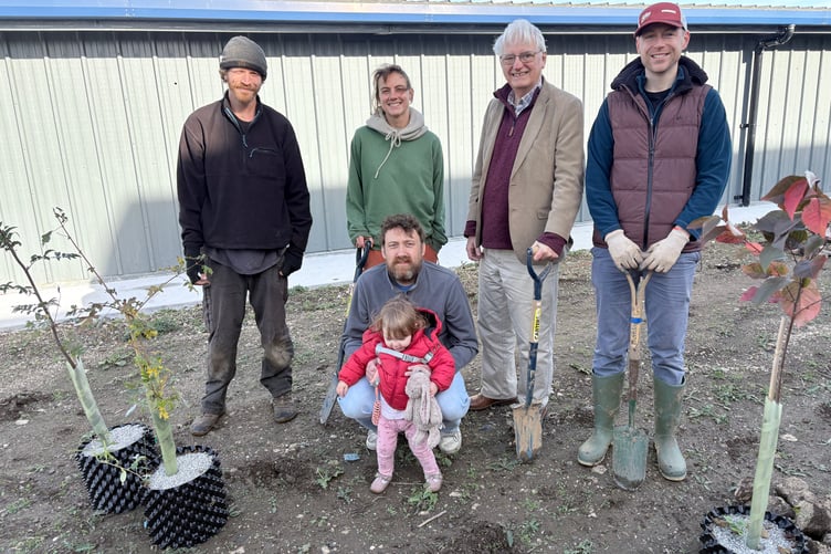 Cllr George Dexter (centre right) and Fleur Ammerlaan from Park Life (centre left) with some of the volunteers preparing the soil for the new wildflower meadow at Okehampton Business Centre.